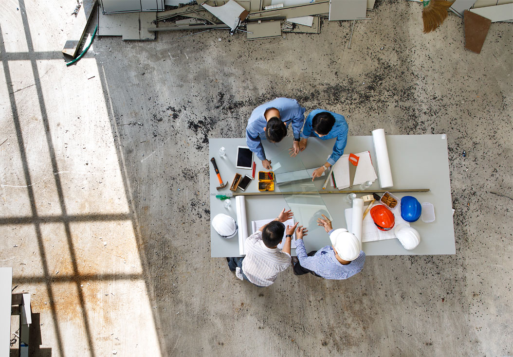 Project portfolio management team meeting around a desk