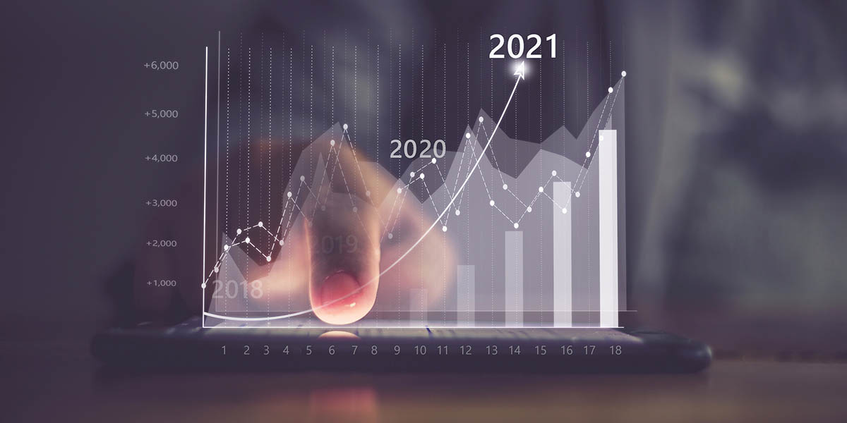 Augmented reality (AR) financial charts showing growing revenue In 2021 floating above digital screen smart phone, businesswoman having meeting about strategy for growth and success